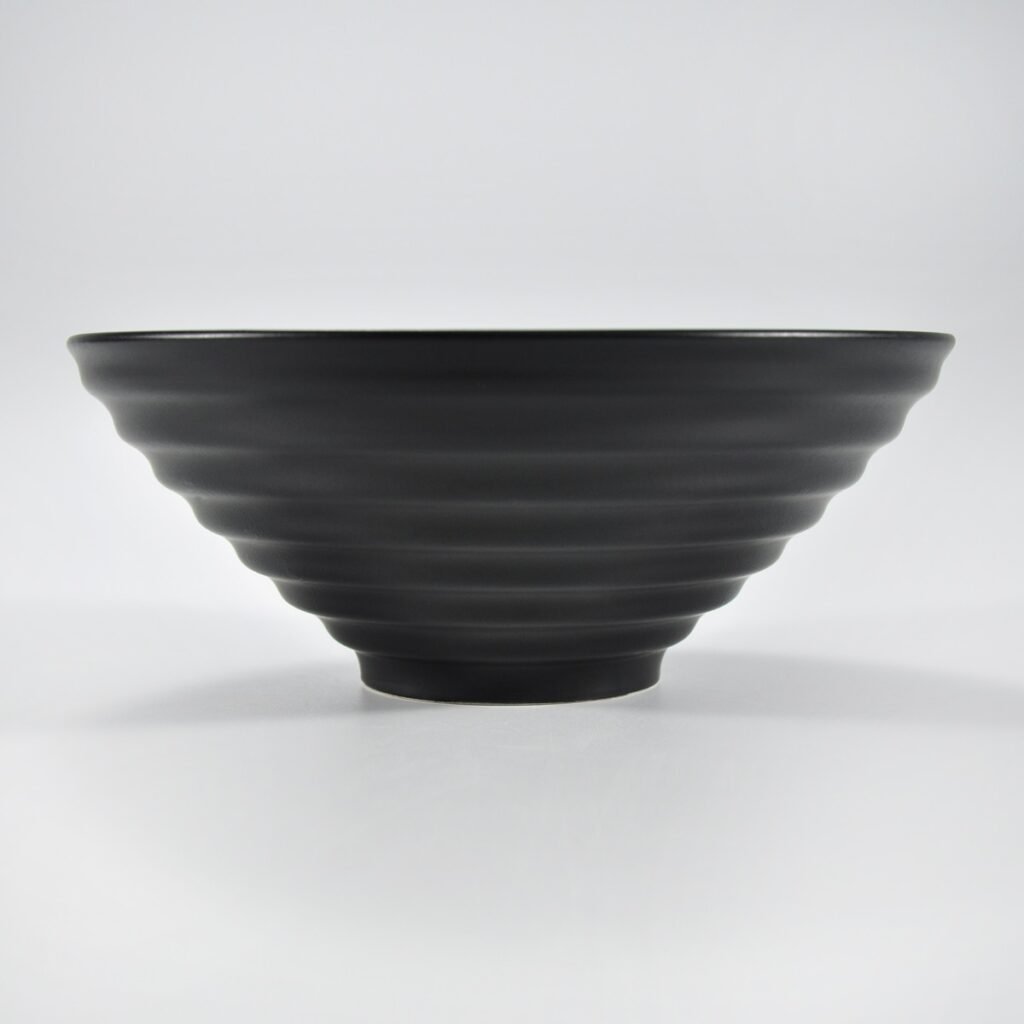Matte black wide-rim embossed ramen bowl by Xuye Ceramics